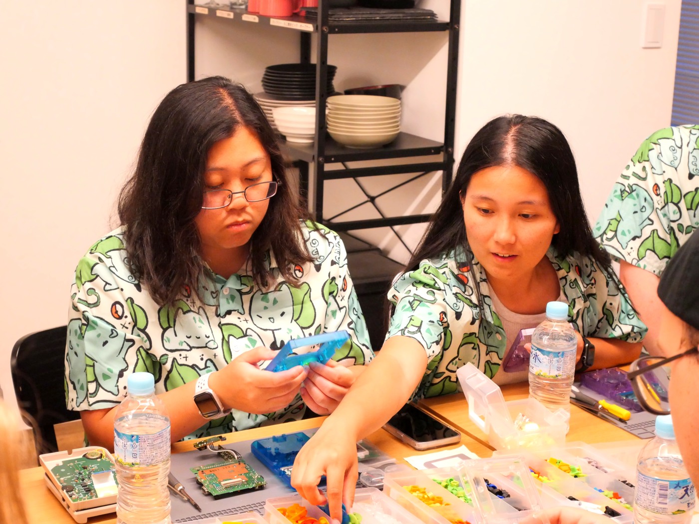 Two participants choosing button colors for their build