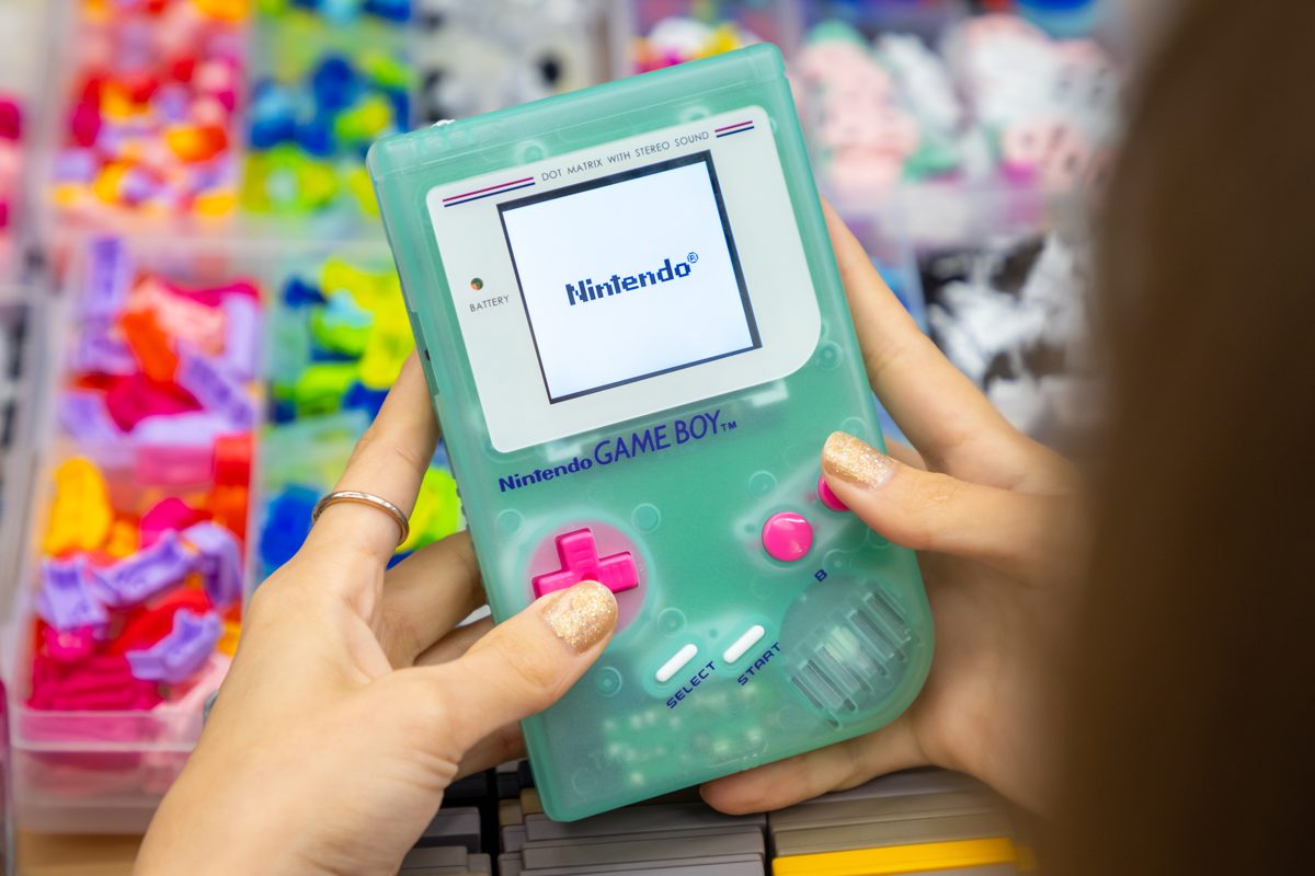 Mint Game Boy with pink buttons on its boot screen