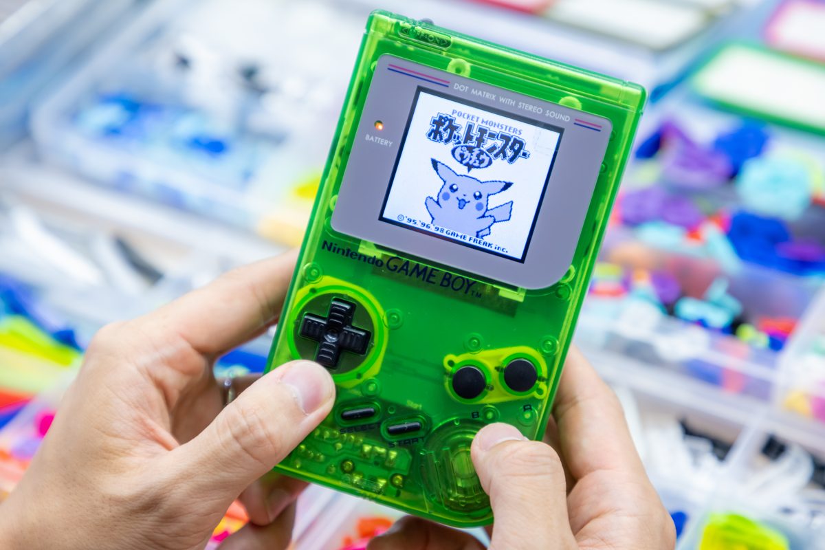 Clear-green Game Boy with its screen lit