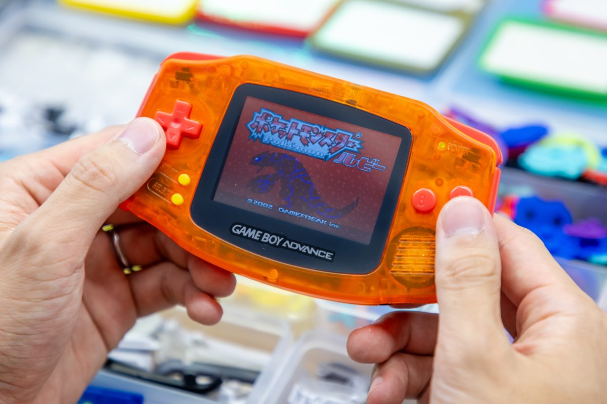 Clear-orange Game Boy Advance with its screen lit
