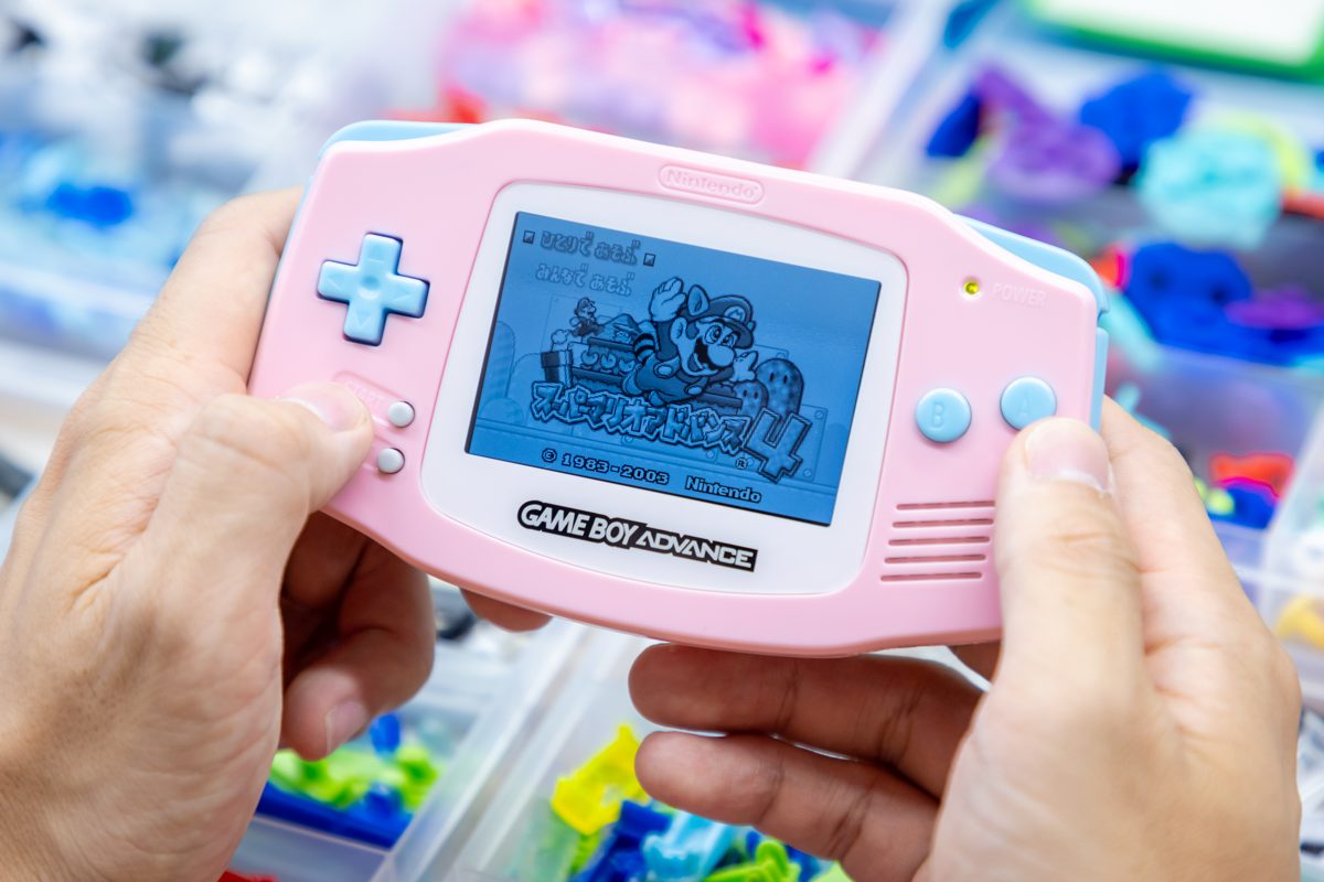 Custom pink Game Boy Advance with its screen lit