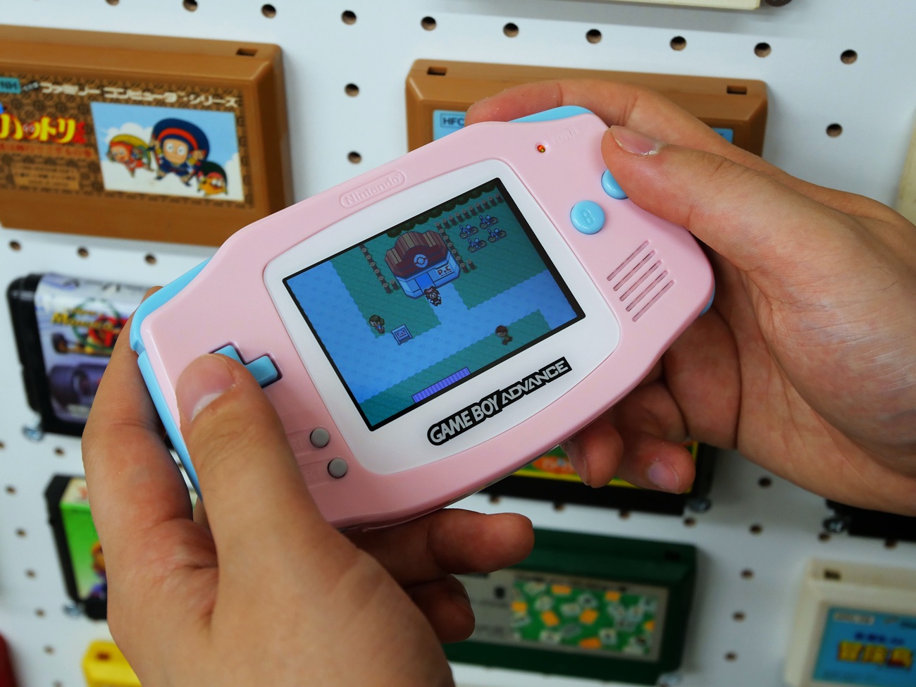 A finished, customized pink Game Boy Advance playing Pokémon