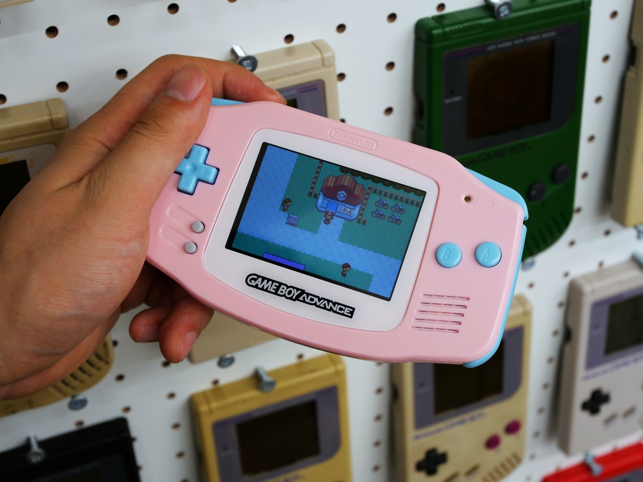 Custom pink Game Boy Advance playing Pokémon