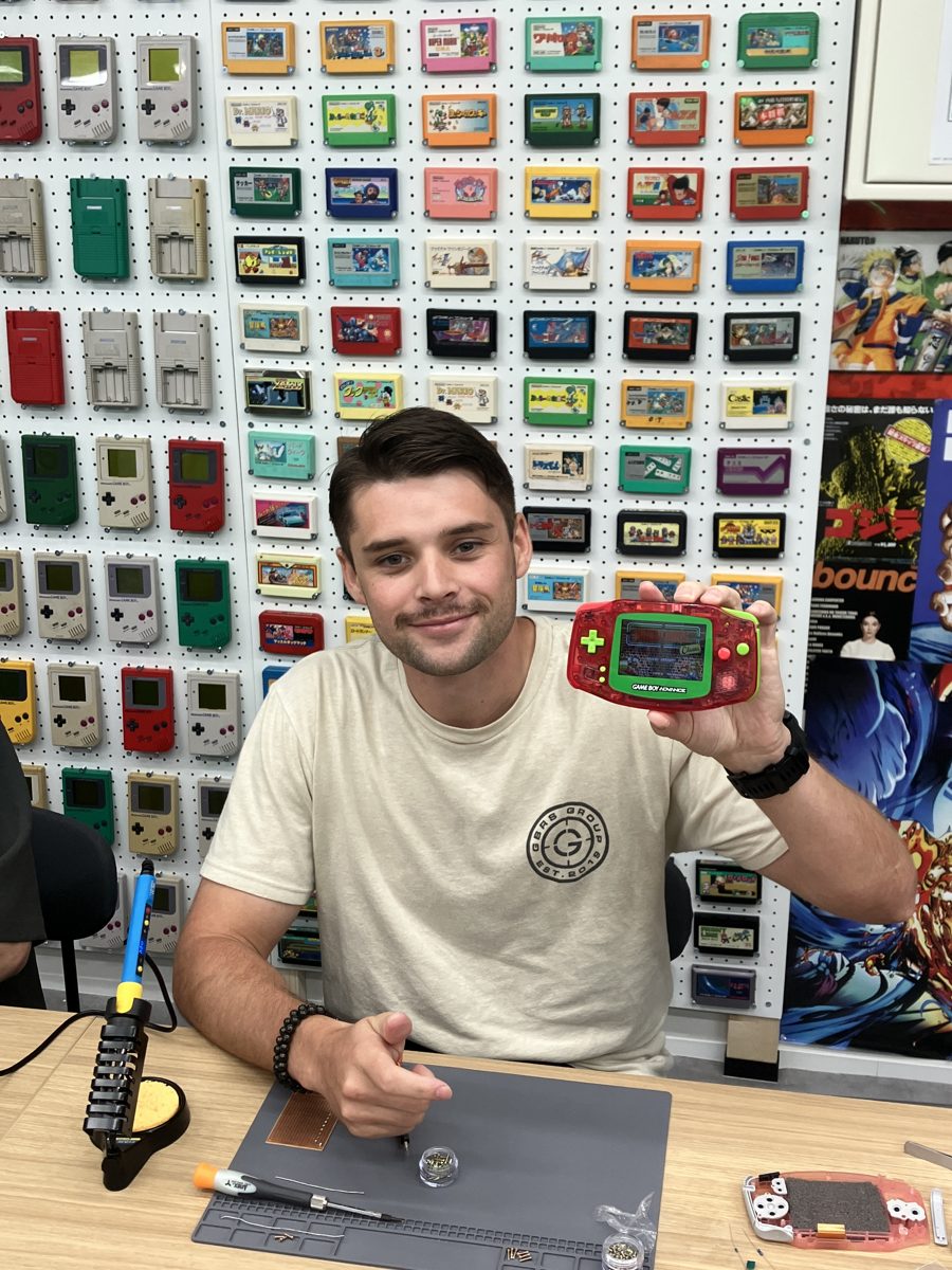 A solo guest proudly showing his finished red Game Boy Advance