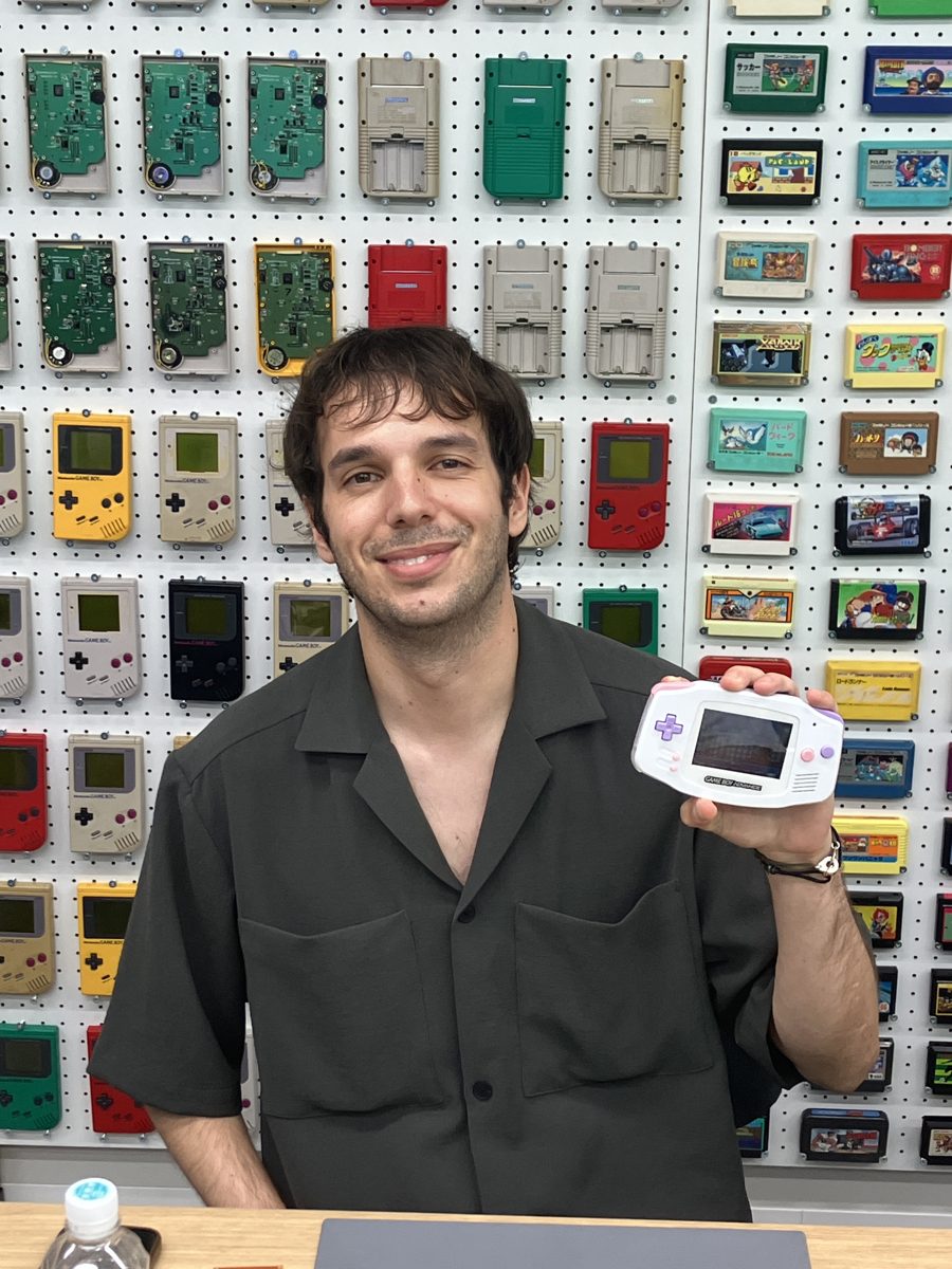 A solo guest holding up his finished white Game Boy Advance