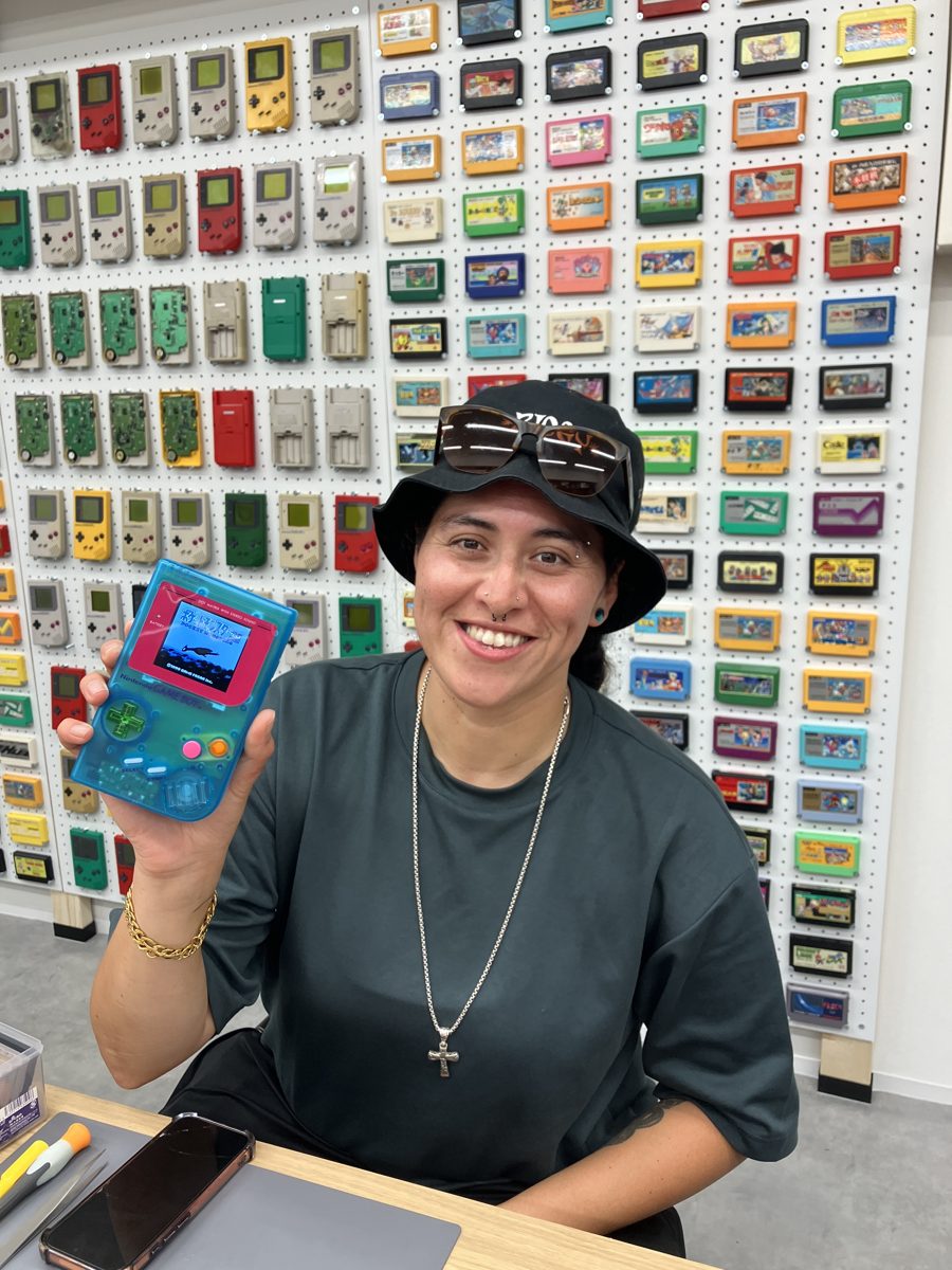 A solo guest showing off her finished clear-blue Game Boy