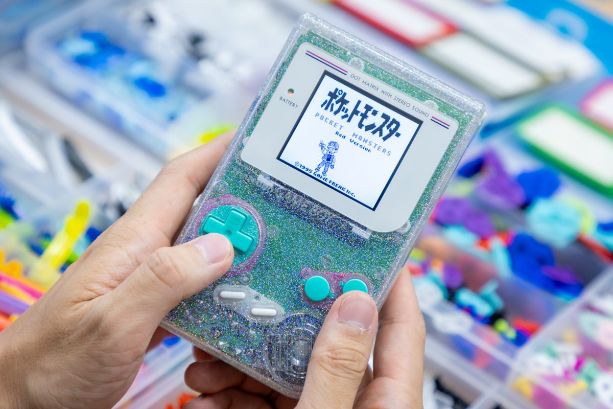 A finished clear-white Game Boy with Pokémon running on its screen